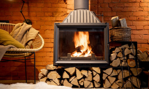 Burning fireplace with firewood at home
